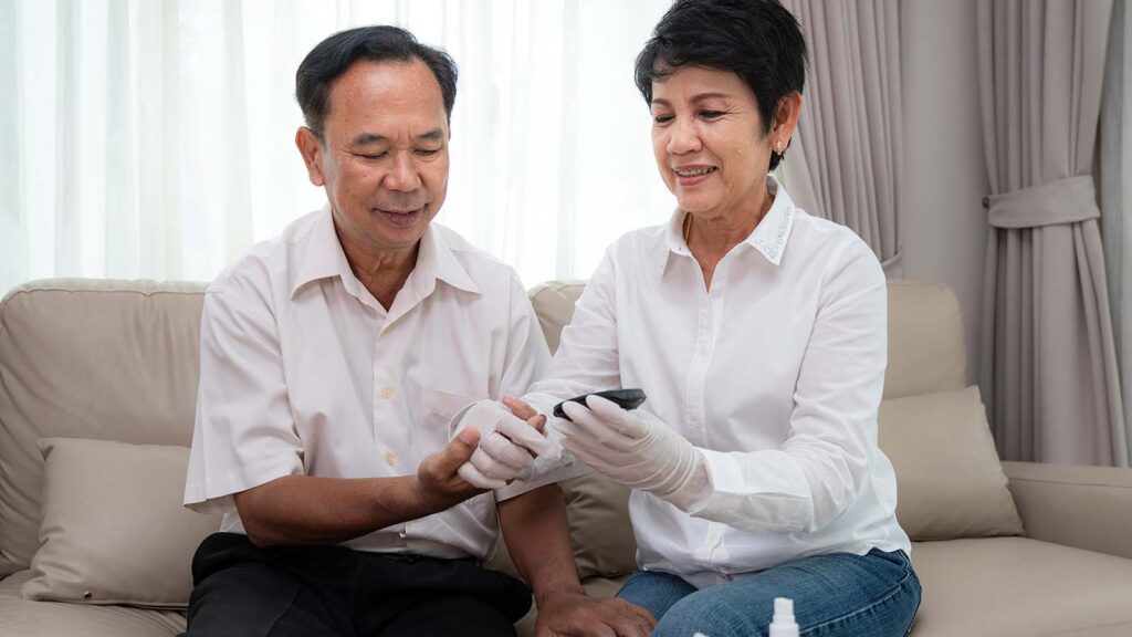 Wife helps husband with glucose reading. Sonder's specialized Medicare Advantage plans offer coverage to help Georgians with chronic conditions like diabetes.