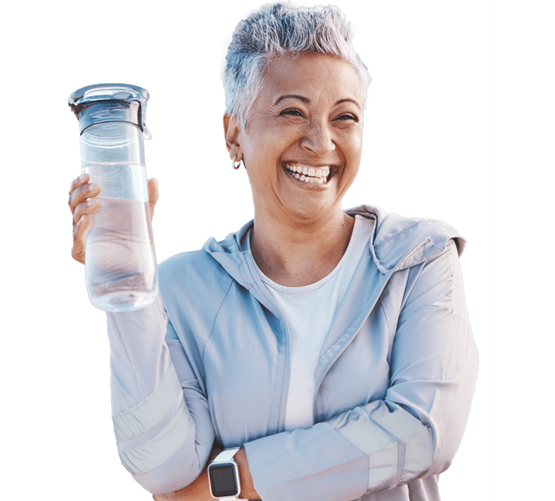 Smiling mature woman holding water bottle